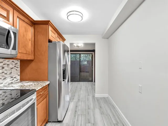 a view of a kitchen cabinets and wooden floor