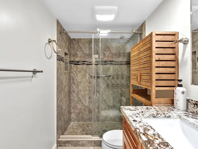 a bathroom with a sink toilet and shower