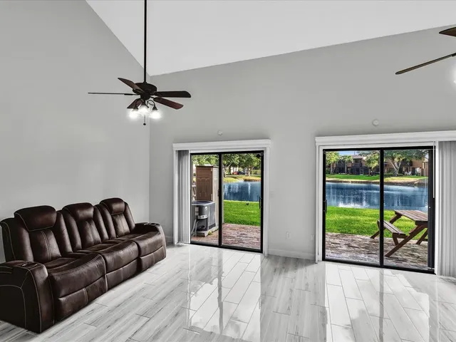 a bedroom with furniture and a large window