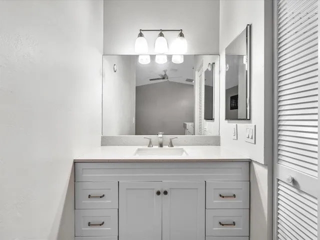 an aerial view of a house with a yard and lake view in back