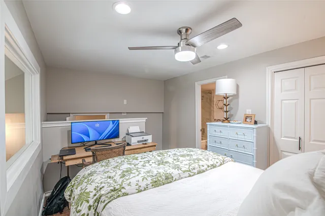 a bedroom with a large bed and a chandelier