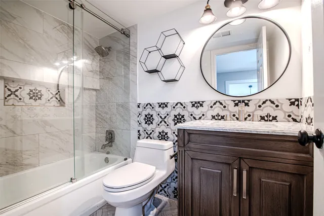 a bathroom with a sink a toilet and a mirror