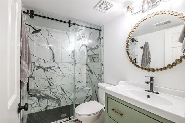 a bathroom with a sink toilet and shower
