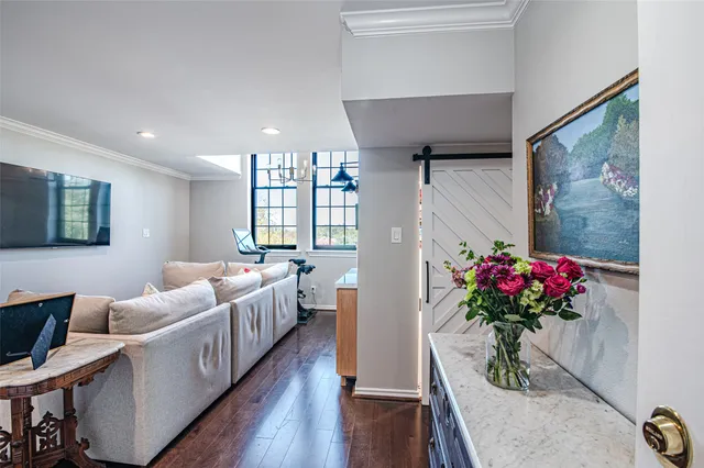 a living room with furniture and flowers