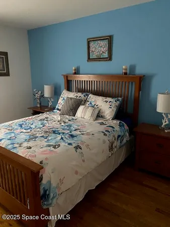 a bed sitting in a bedroom next to a lamp