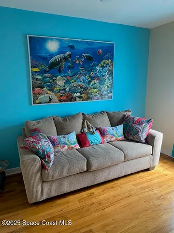 a room with wooden floor and window