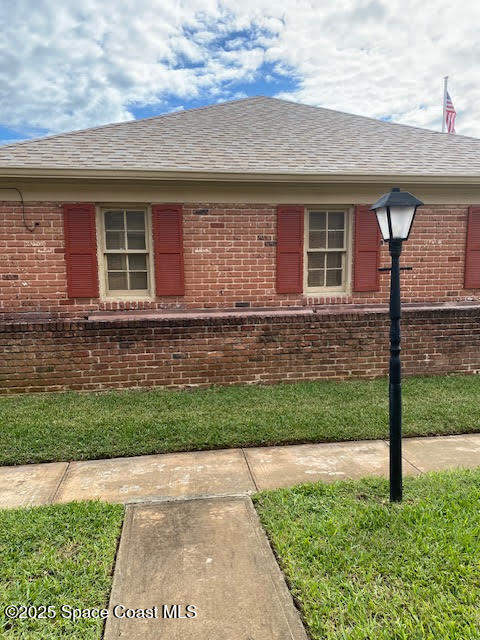926 Jamestown Avenue, Unit 93 Indian Harbour Beach, FL 32937 - Photo 26 of 31 a front view of a house with a yard