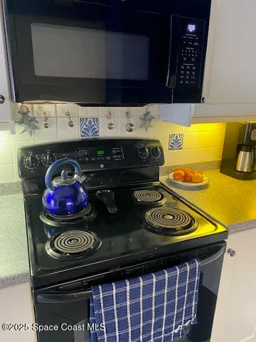a kitchen with a stove and a microwave