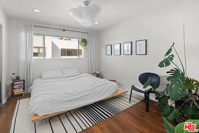a bedroom with bed and a chandelier