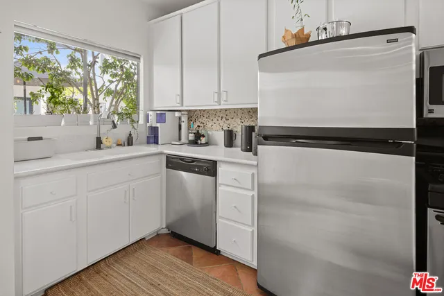 a kitchen with a white cabinets and white appliances