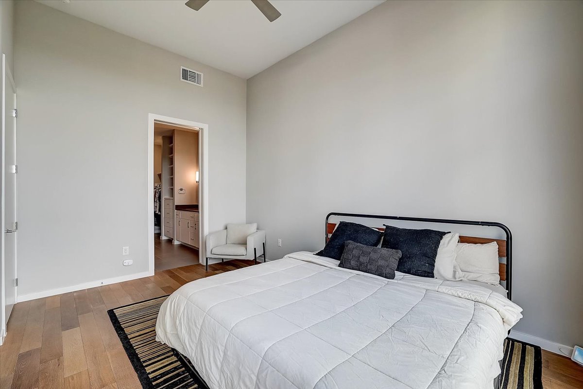 5921 Hiline Road, Unit 1204 Austin, TX 78734 - Photo 26 of 36 Bedroom featuring wood-type flooring, connected bathroom, and ceiling fan