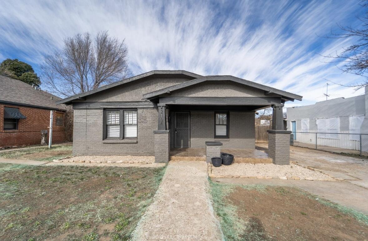 a front view of a house with yard outdoor seating and barbeque oven