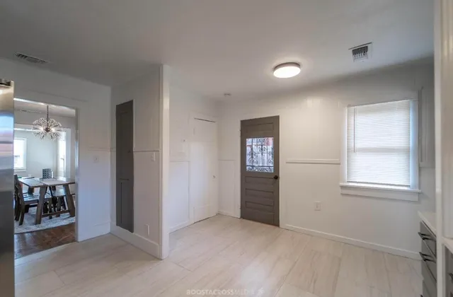 an empty room with windows and entrance