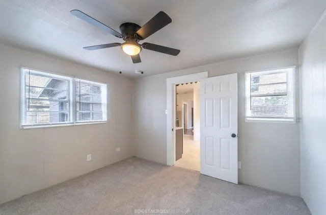 a view of an empty room with a window