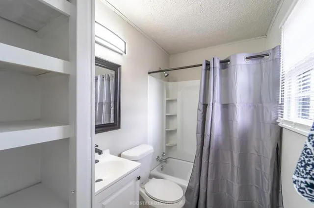 a bathroom with a sink toilet and shower