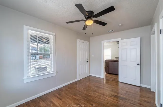 a view of a livingroom with a ceiling fan and window