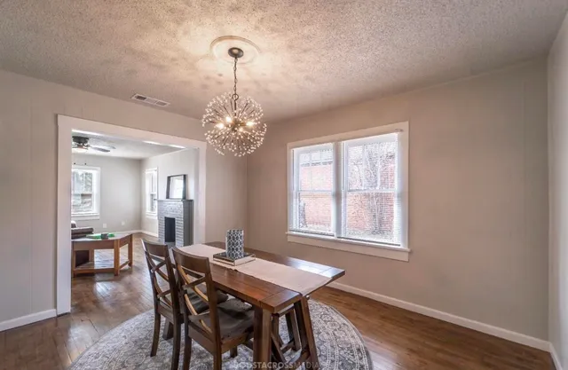 a view of a dining room with furniture and window