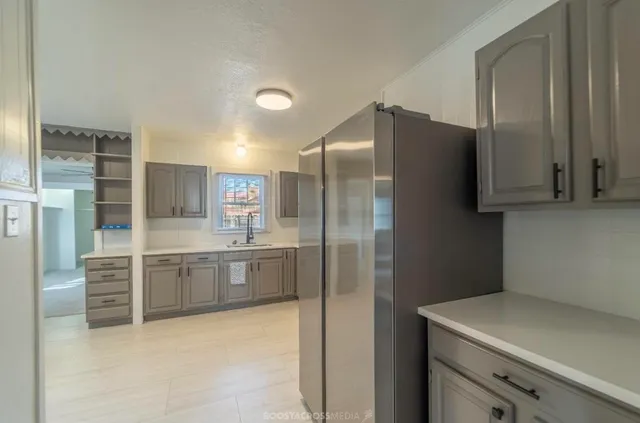 a kitchen with stainless steel appliances granite countertop a refrigerator and a sink