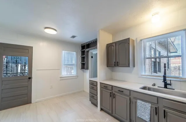 a kitchen with stainless steel appliances granite countertop a sink and wooden cabinets