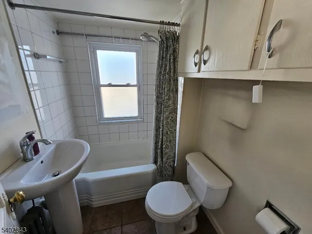 an empty room with windows a fireplace