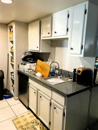 a kitchen with a sink and cabinets