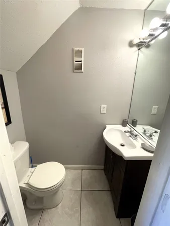 a bathroom with a sink toilet and mirror