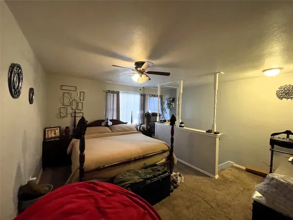 a bedroom with two beds and a desk