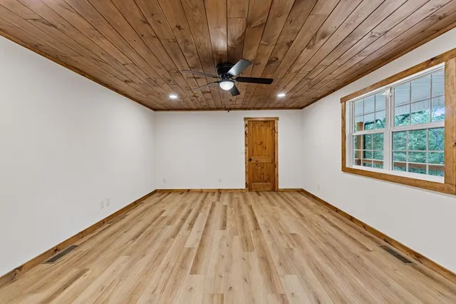 a view of a room with wooden floor