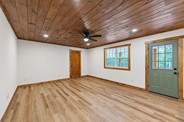 a view of a room with wooden floor