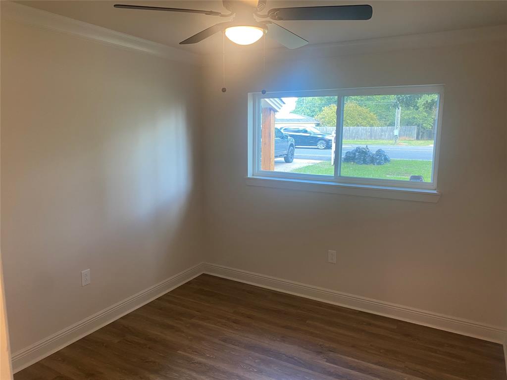 1609 Northgate Road Bossier City, LA 71112 - Photo 10 of 17 an empty room with wooden floor and windows