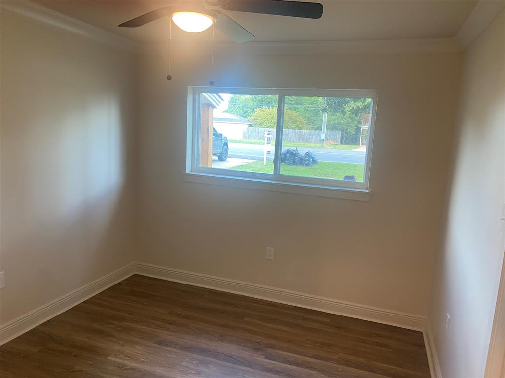 1609 Northgate Road Bossier City, LA 71112 - Photo 11 of 17 an empty room with wooden floor and windows