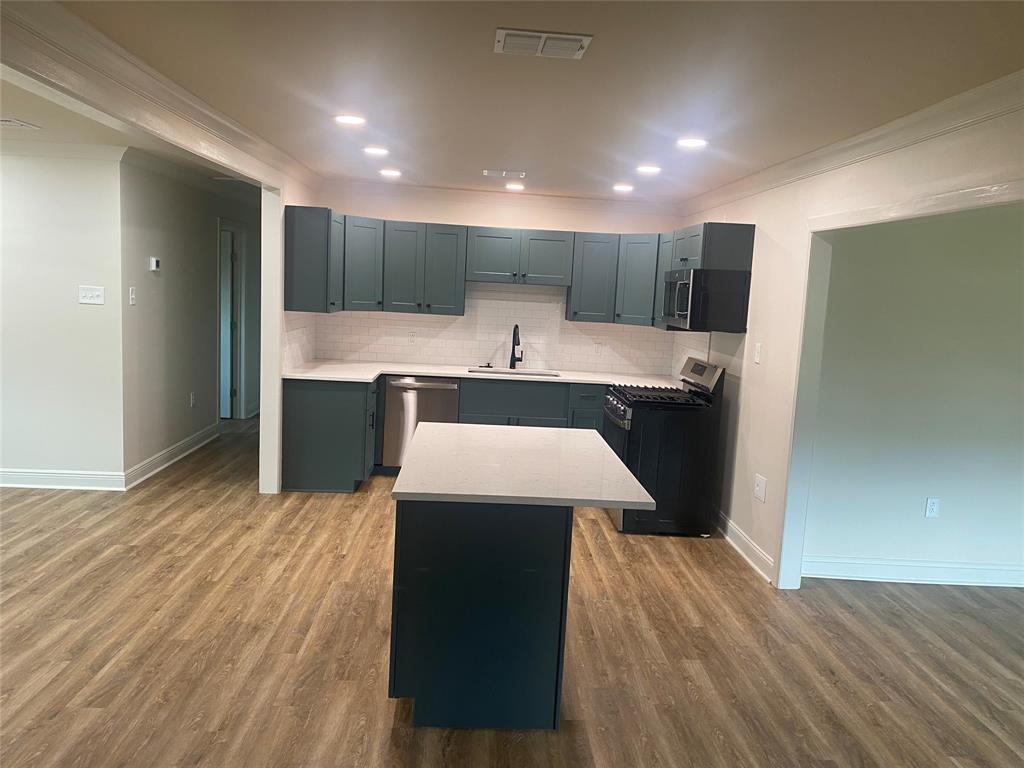 1609 Northgate Road Bossier City, LA 71112 - Photo 4 of 17 a kitchen with a sink and a refrigerator