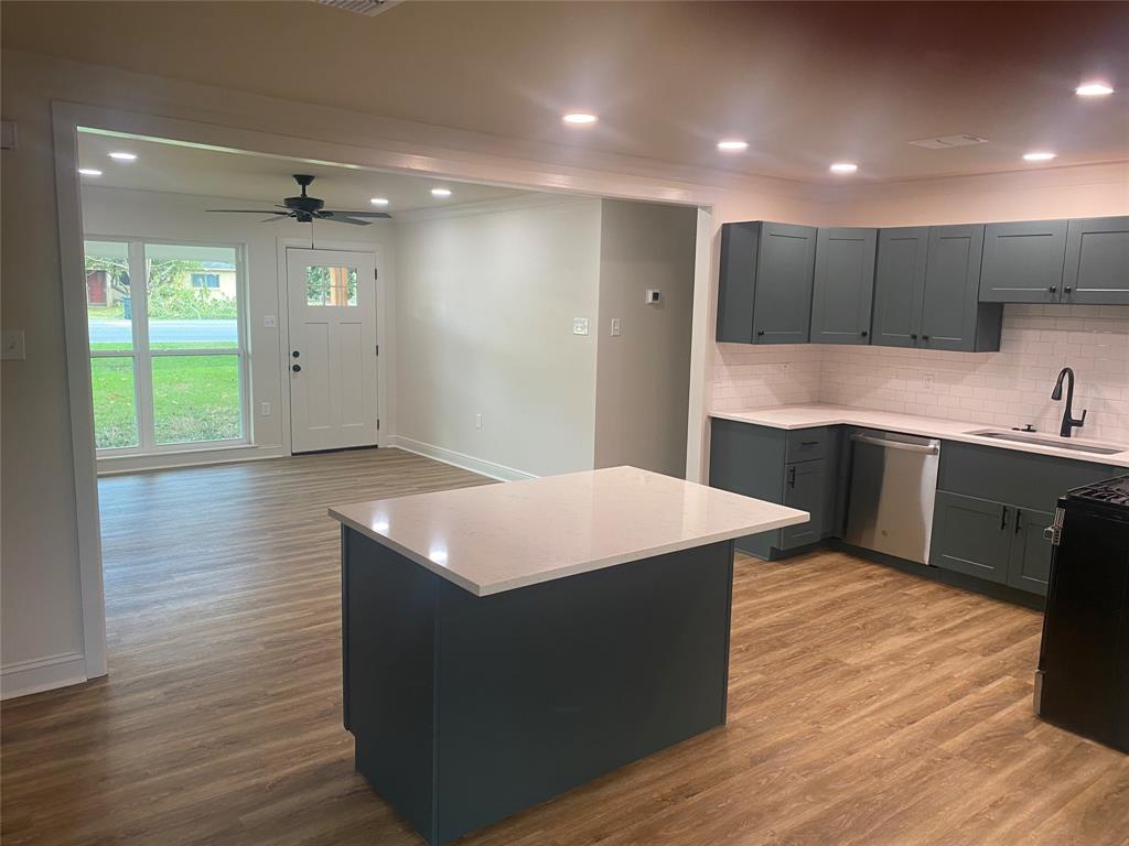 1609 Northgate Road Bossier City, LA 71112 - Photo 5 of 17 a kitchen with kitchen island a sink dishwasher stove and wooden cabinets