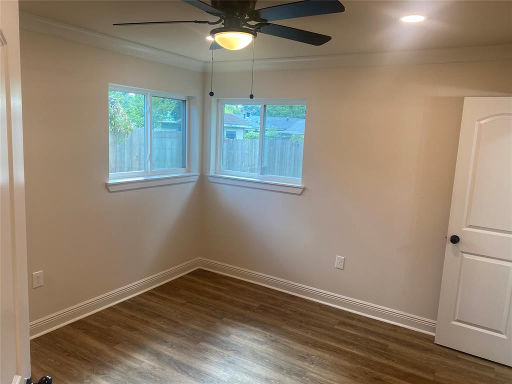 1609 Northgate Road Bossier City, LA 71112 - Photo 8 of 17 an empty room with wooden floor and windows