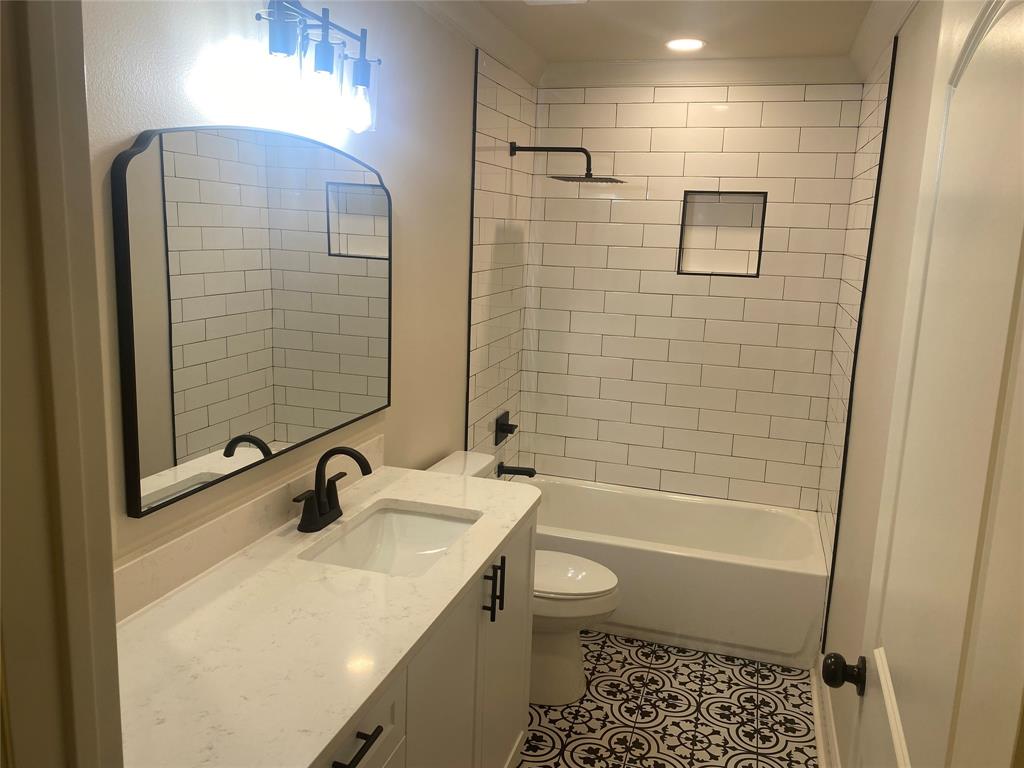 1609 Northgate Road Bossier City, LA 71112 - Photo 9 of 17 a bathroom with a sink a toilet a mirror and shower