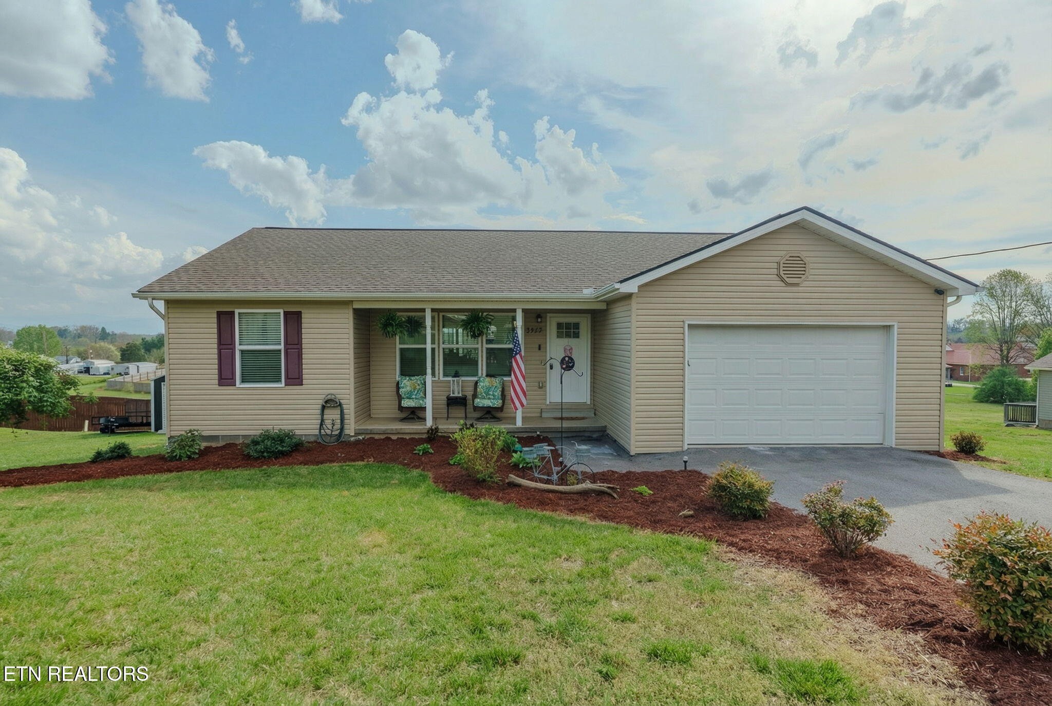 a front view of a house with a yard and outdoor seating