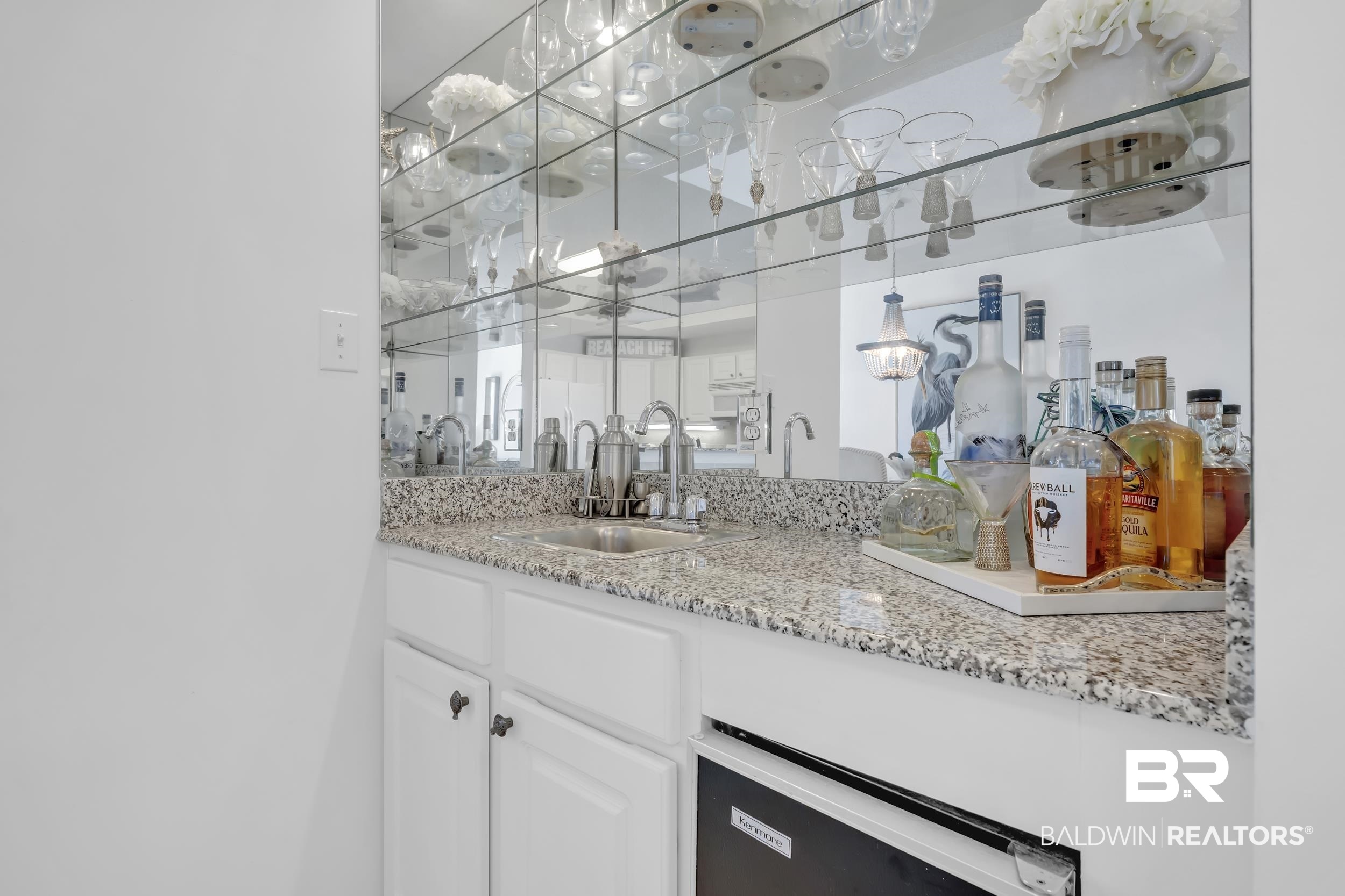 27282 Canal Road, Unit 104 Orange Beach, AL 36561 - Photo 27 of 79 Bar with light stone countertops, white cabinets, dishwasher, and pendant lighting