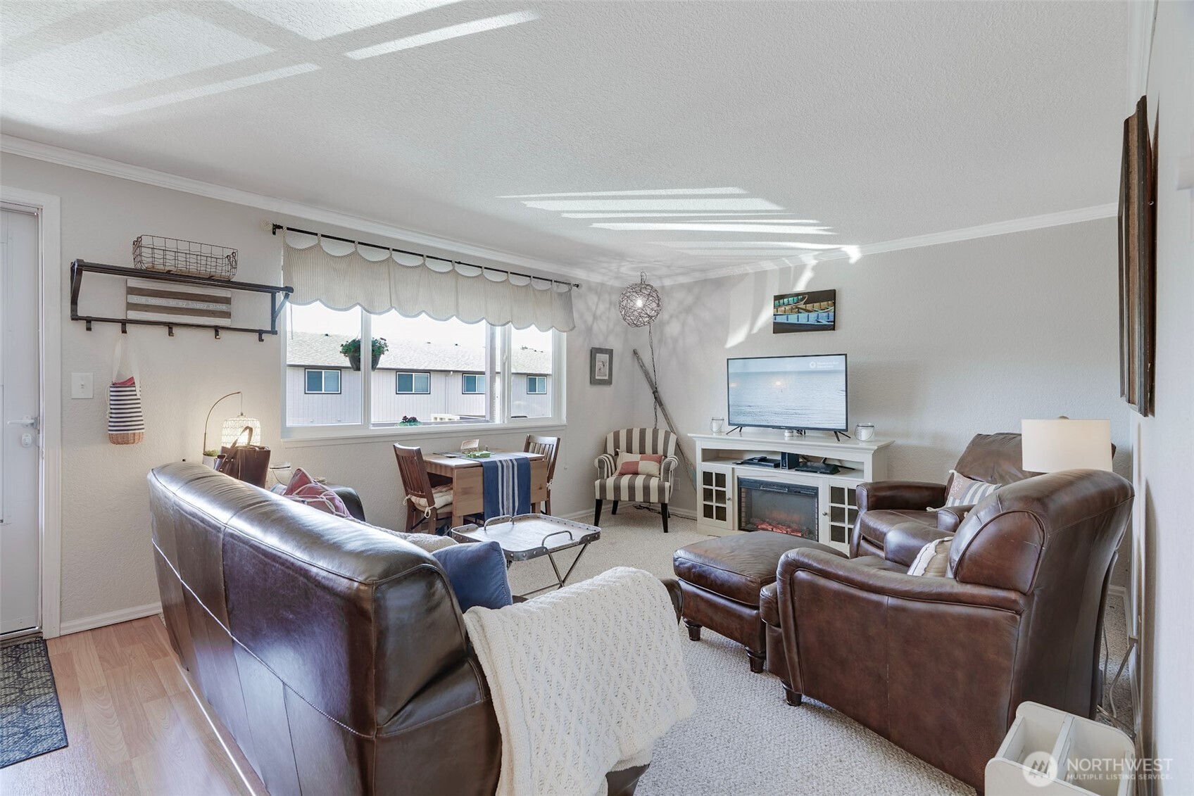1420 48th Street, Unit B10 Seaview, WA 98644 - Photo 1 of 20 a living room with furniture and a flat screen tv