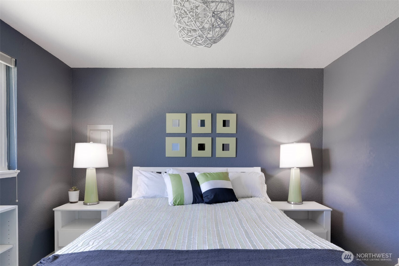 1420 48th Street, Unit B10 Seaview, WA 98644 - Photo 12 of 20 a bedroom with a bed and a lamp