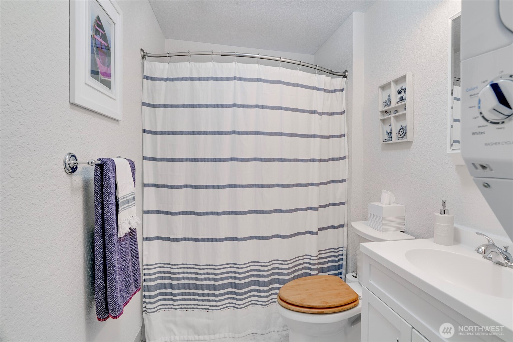 1420 48th Street, Unit B10 Seaview, WA 98644 - Photo 15 of 20 a bathroom with a sink a toilet and a mirror
