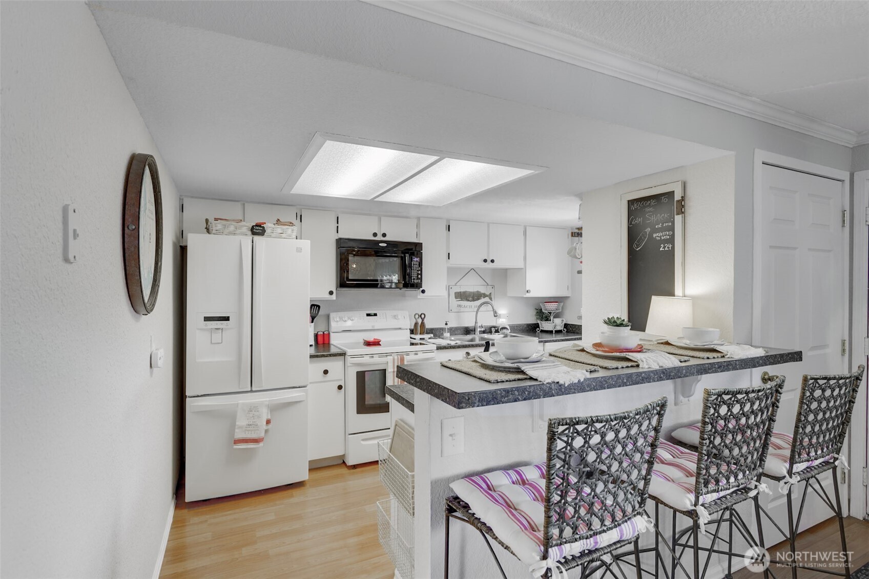 1420 48th Street, Unit B10 Seaview, WA 98644 - Photo 6 of 20 a kitchen that has a lot of cabinets a sink and a stove in it