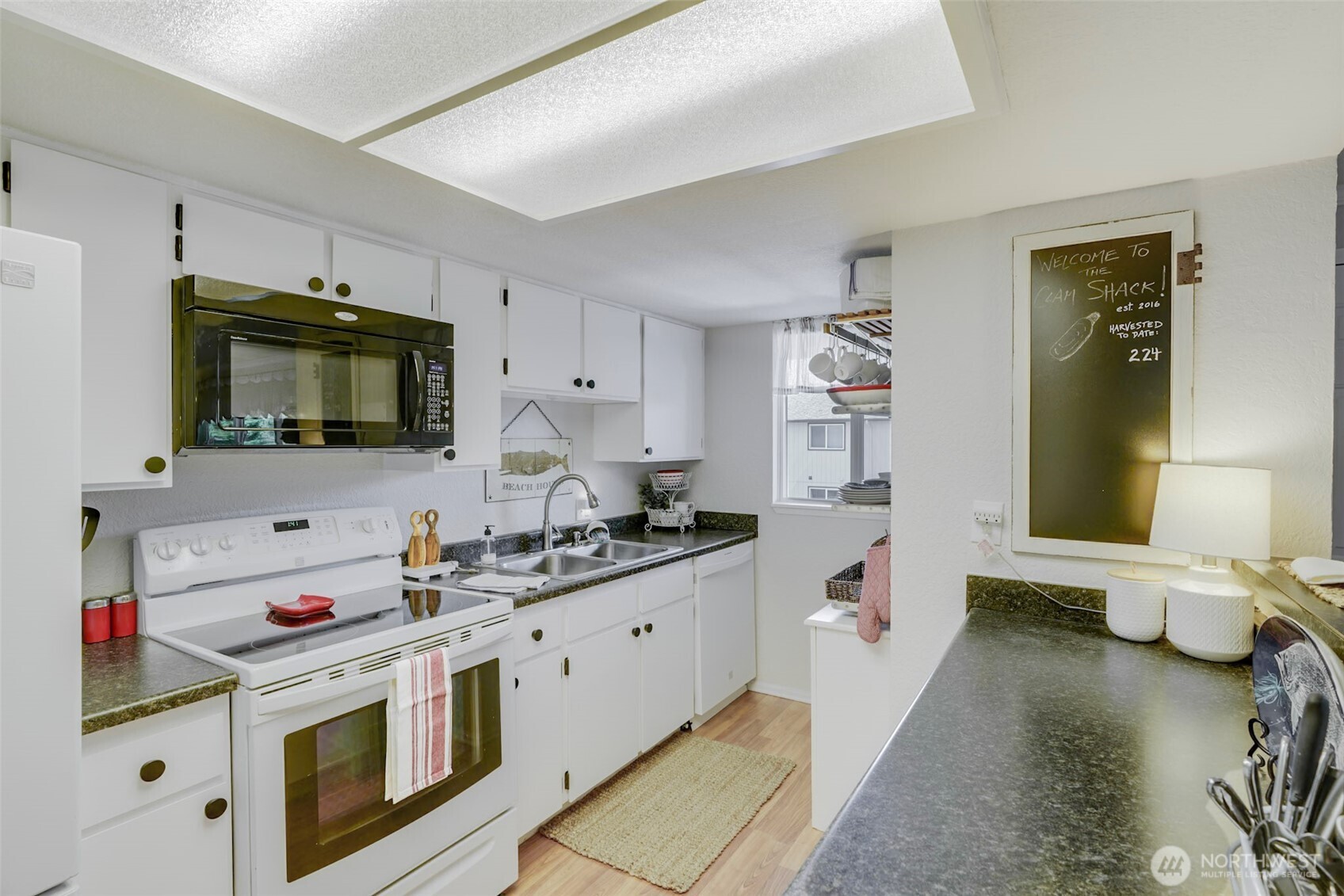 1420 48th Street, Unit B10 Seaview, WA 98644 - Photo 7 of 20 a kitchen with a sink stove and microwave