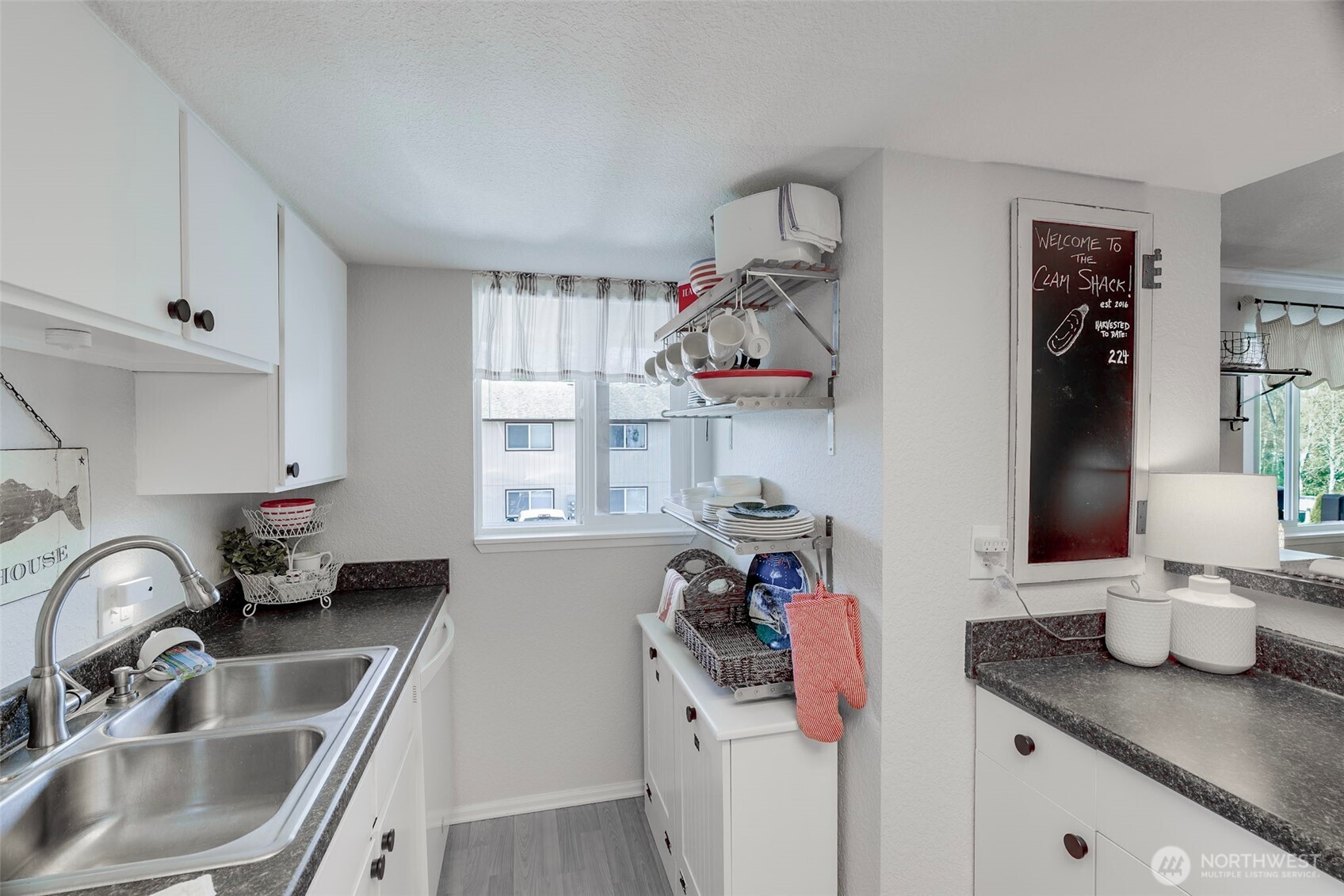 1420 48th Street, Unit B10 Seaview, WA 98644 - Photo 8 of 20 a kitchen with a sink cabinets and appliances
