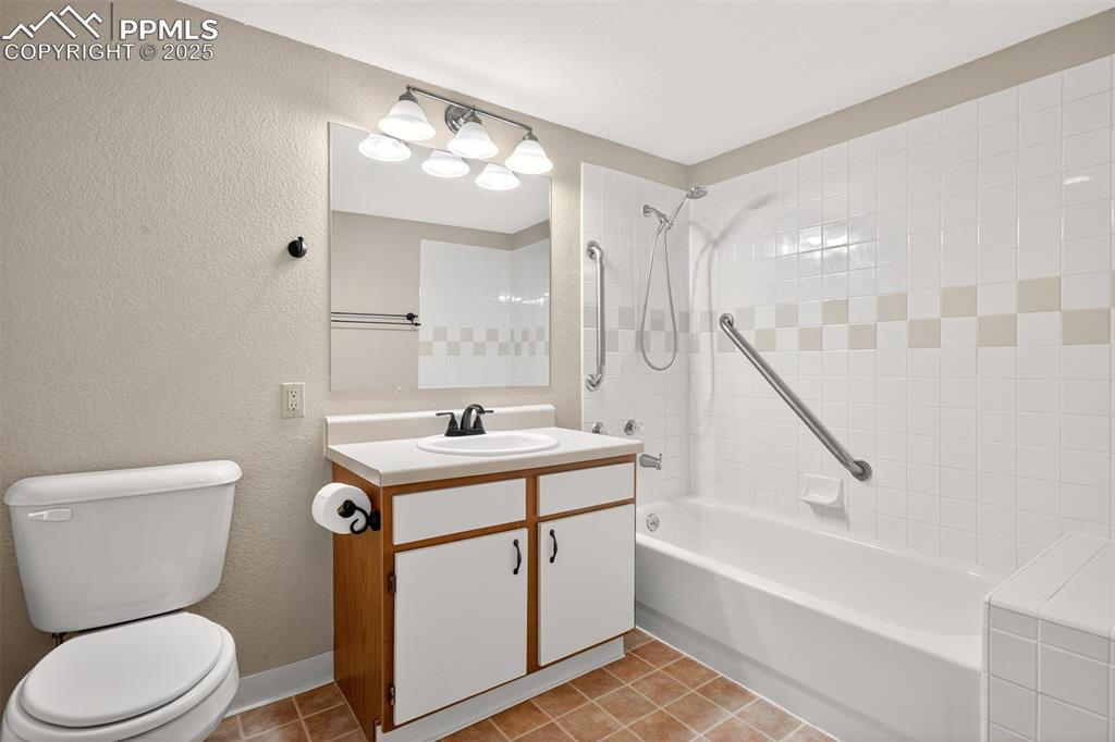 2190 Alicia Point, Unit 101 Colorado Springs, CO 80919 - Photo 17 of 33 a bathroom with a sink a toilet a mirror and bathtub