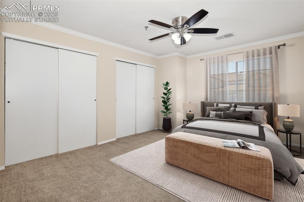 2190 Alicia Point, Unit 101 Colorado Springs, CO 80919 - Photo 19 of 33 a spacious bedroom with a bed and a ceiling fan