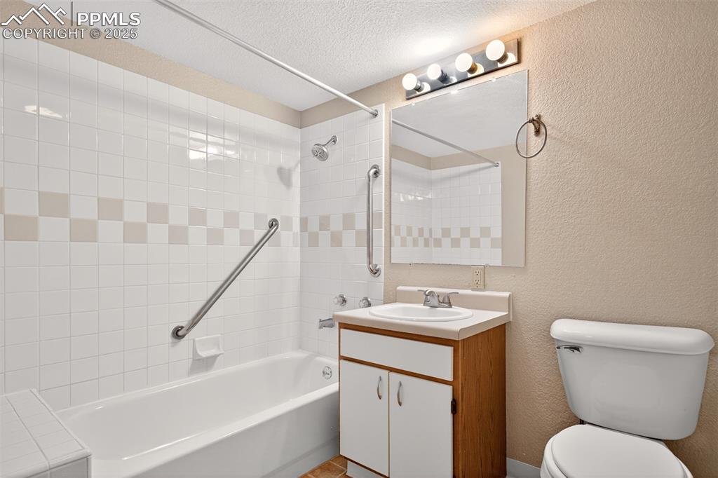 2190 Alicia Point, Unit 101 Colorado Springs, CO 80919 - Photo 21 of 33 a bathroom with a granite countertop sink toilet and shower