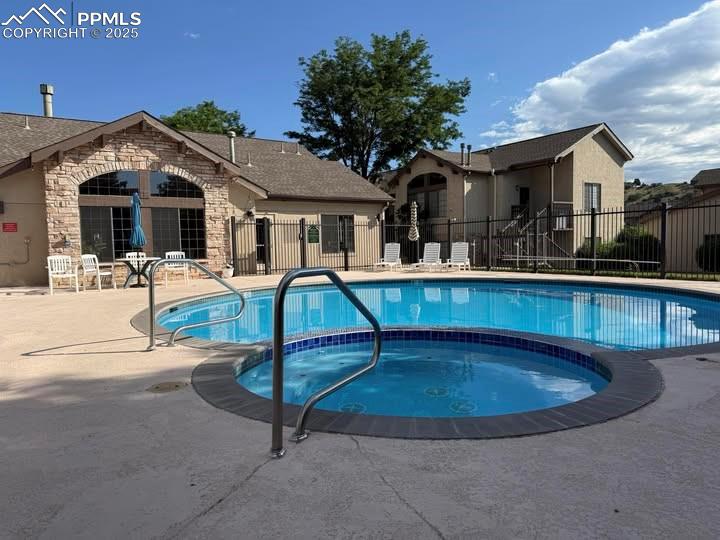 2190 Alicia Point, Unit 101 Colorado Springs, CO 80919 - Photo 28 of 33 a front view of house with yard outdoor seating and trees in the background