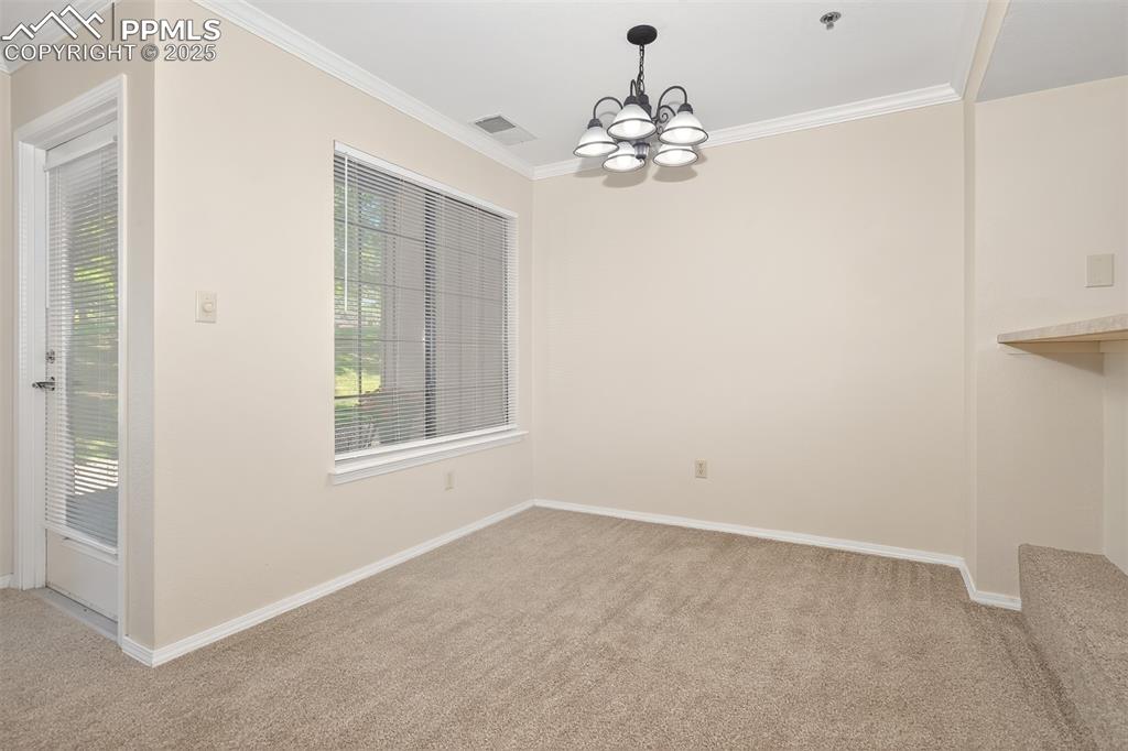 2190 Alicia Point, Unit 101 Colorado Springs, CO 80919 - Photo 5 of 33 a view of livingroom with chandelier