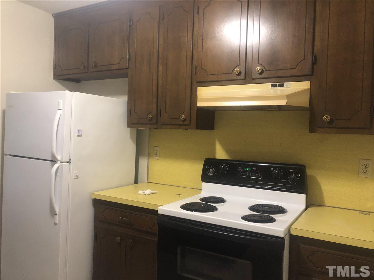 926 Jason Court Cary, NC 27511 - Photo 2 of 10 a kitchen with a stove and a refrigerator