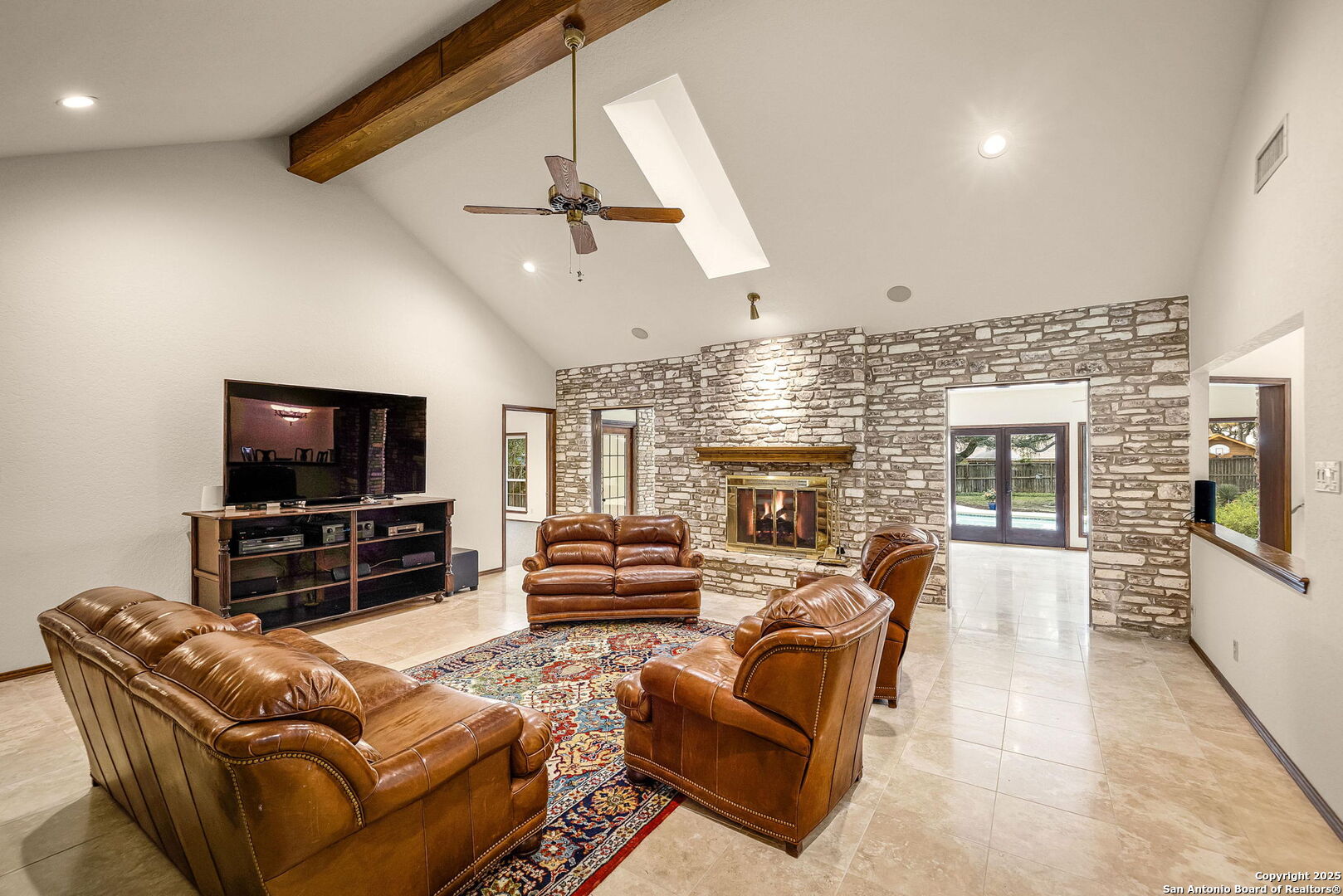 9606 Meadow Rue Garden Ridge, TX 78266 - Photo 16 of 60 a living room with furniture a flat screen tv and a fireplace